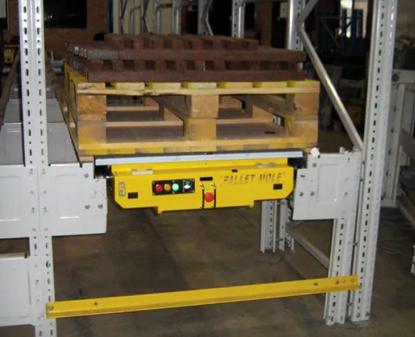 Pallet Mole shuttle device positioned under a pallet load